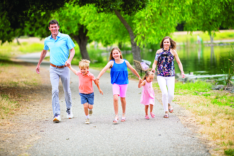 Free Photos - A Joyful Moment As A Family Of Four Poses For A Photograph.  The Family Members, A Man, A Woman, And Two Children, Are Standing Close To  Each Other And